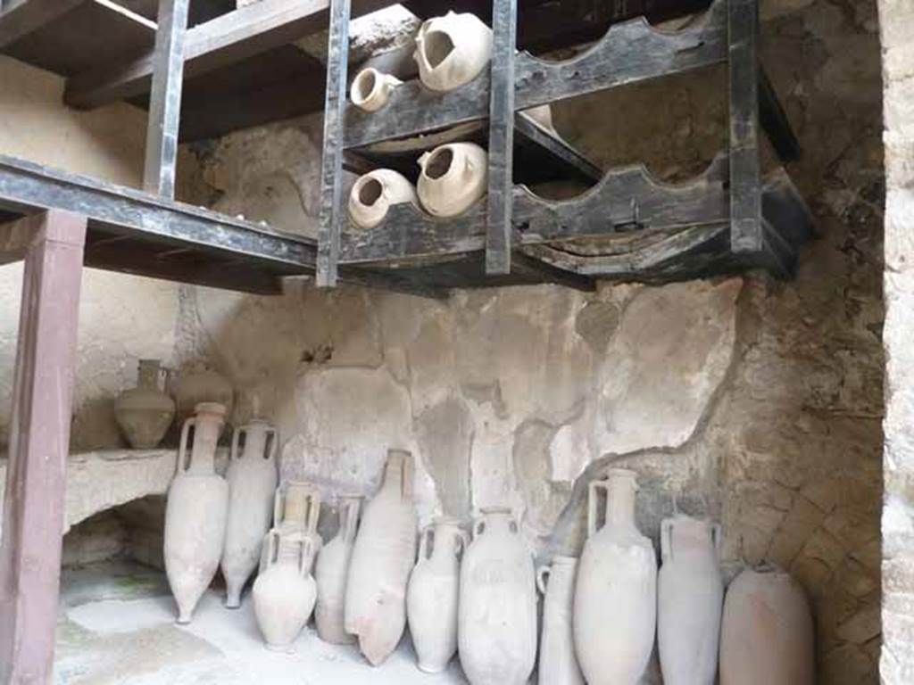 Ins. V.6. May 2010. Hearth in south-east corner, and amphorae on south side.